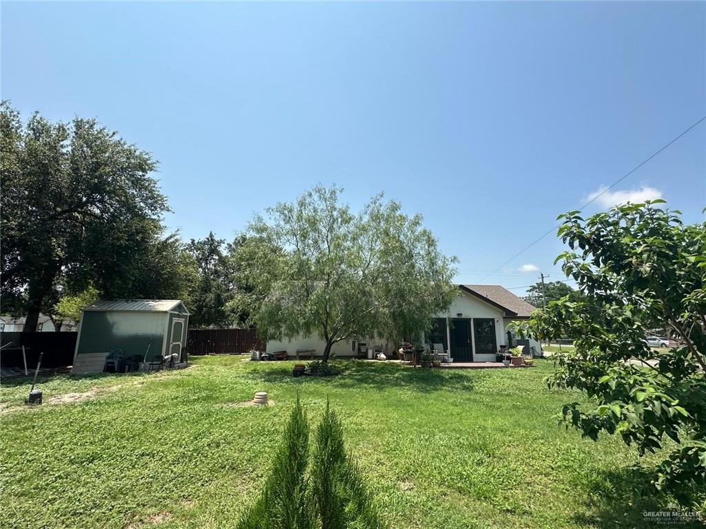 330 West Adams Street Falfurrias, TX 78355 - Photo 2 of 14 a front view of a house with a garden