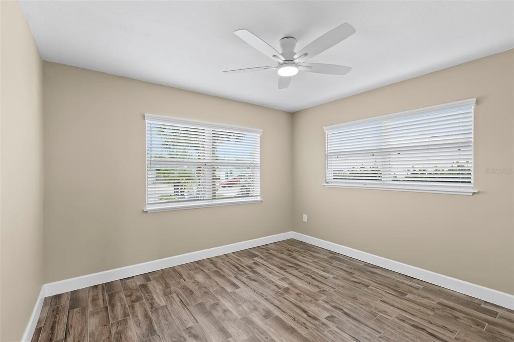 708 Sunset Cove Madeira Beach, FL 33708 - Photo 24 of 61 a view of an empty room with wooden floor and a window