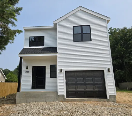 a front view of a house with a garage