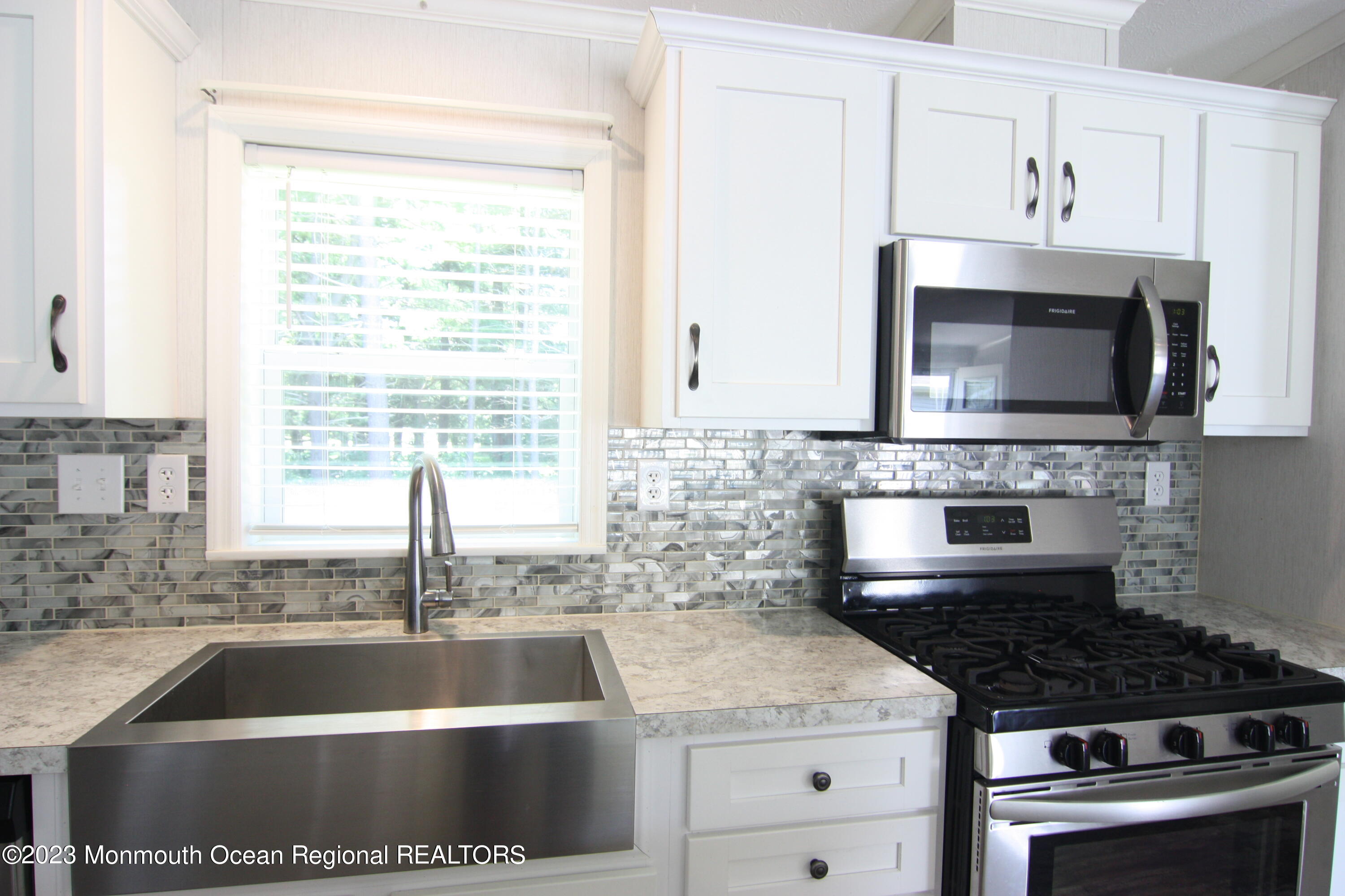 512 Rosalind Road Freehold, NJ 07728 - Photo 3 of 17 a kitchen with granite countertop a sink stainless steel appliances and cabinets