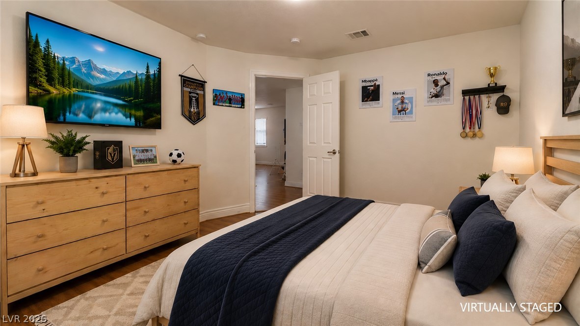 87 Tall Ruff Drive Las Vegas, NV 89148 - Photo 70 of 71 Hardwood floors and ample natural light define this cozy and comfortable bedroom.