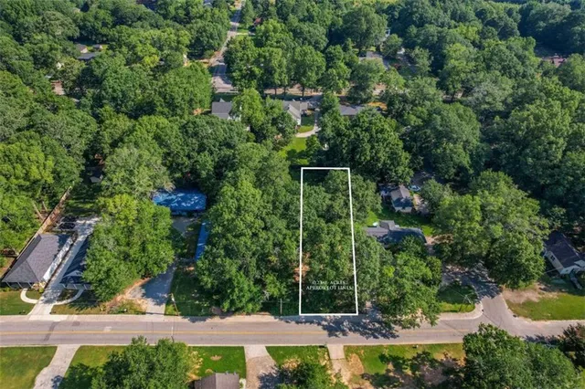 an aerial view of a house with yard