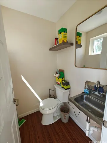 a white toilet sitting next to a bathroom sink and vanity