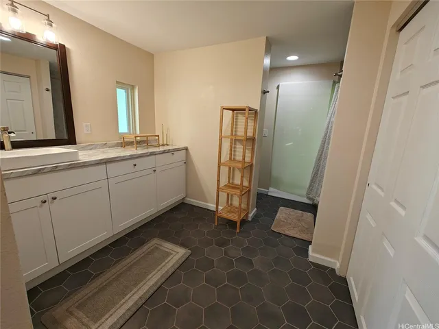 a spacious bathroom with double vanity and a mirror