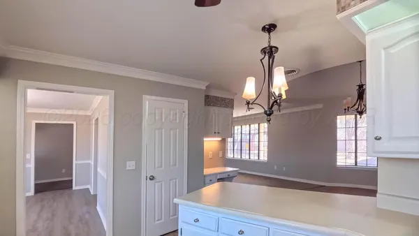 a bathroom with a sink a light fixture and a window