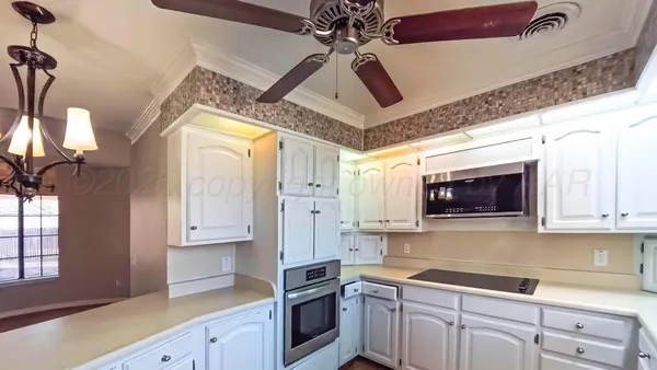a kitchen with a sink cabinets and window
