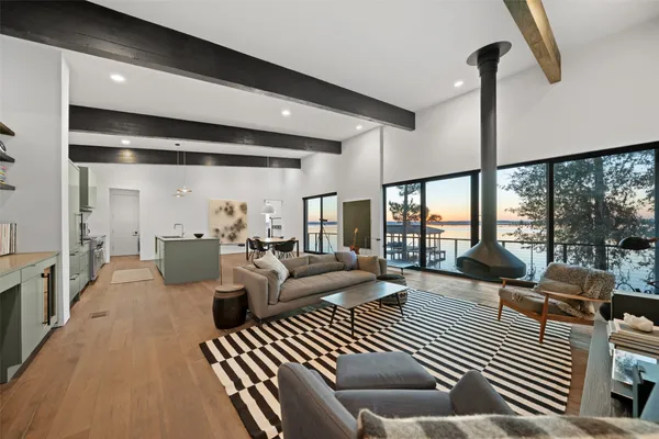 a living room with furniture floor to ceiling window and tables