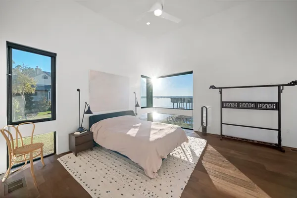 a bedroom with a bed and painting on the wall