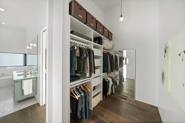 a bathroom with a granite countertop sink a toilet and mirror