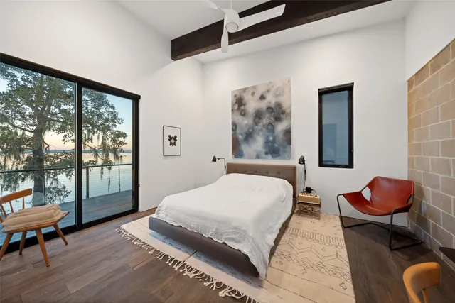 a bedroom with a bed and glass door