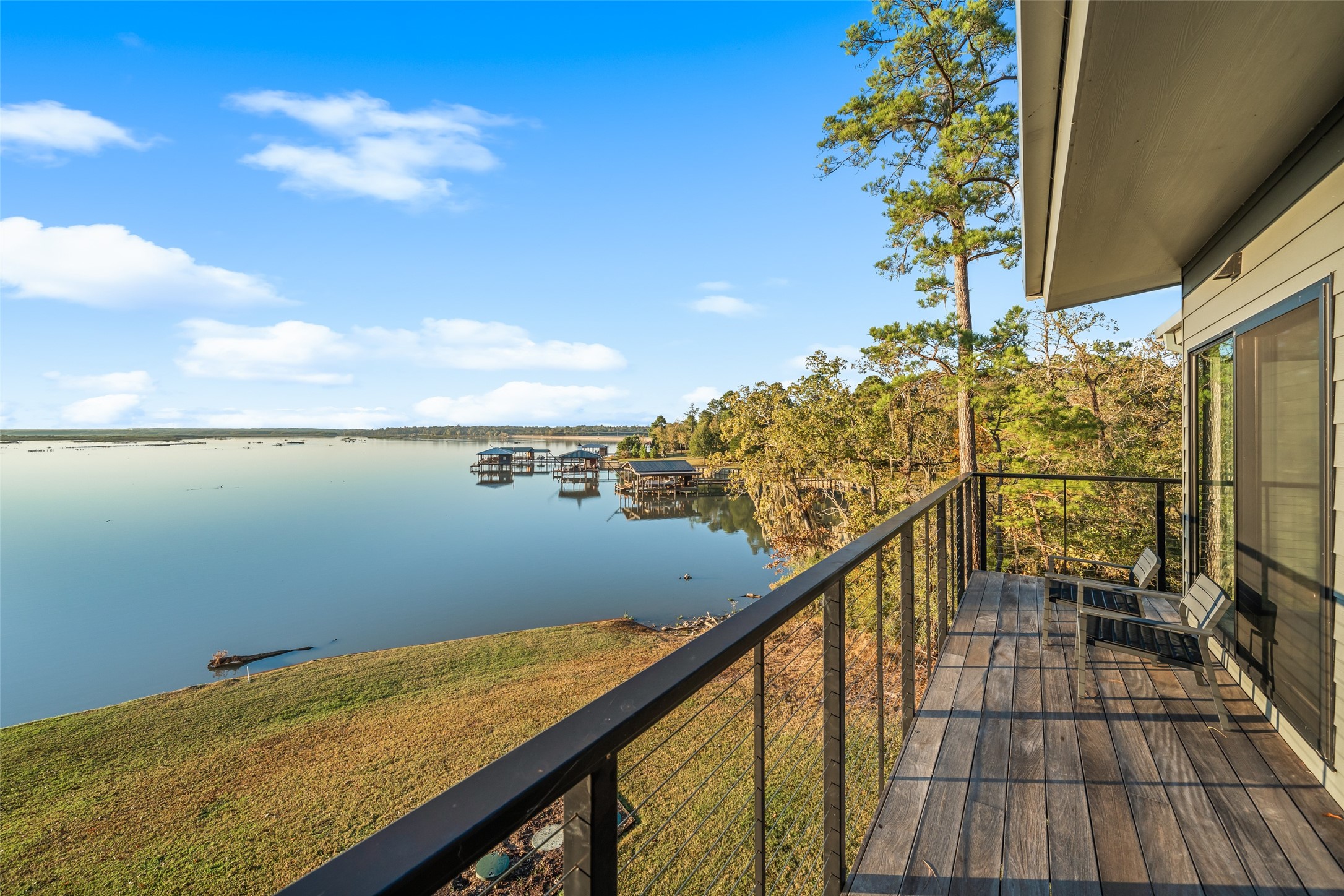 152 Lori Lane Trinity, TX 75862 - Photo 22 of 50 a view of a balcony with wooden floor and stairs