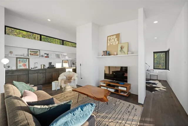 a living room with furniture a fireplace and a flat screen tv