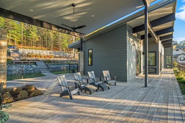 a view of a patio with table and chairs and wooden floor