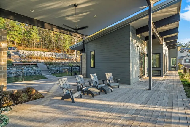 a view of a patio with table and chairs and wooden floor