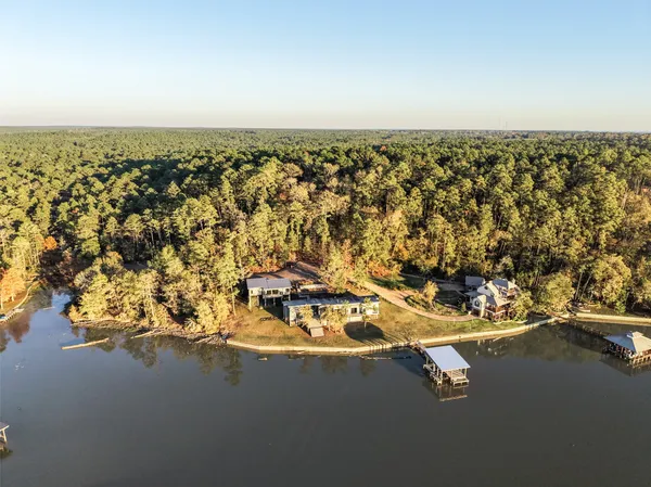 an aerial view of a house with a lake view