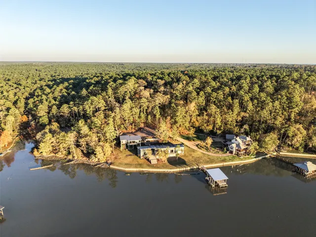 an aerial view of a house with a lake view