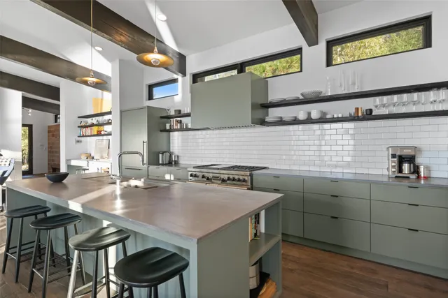 a kitchen with stainless steel appliances granite countertop a sink and cabinets