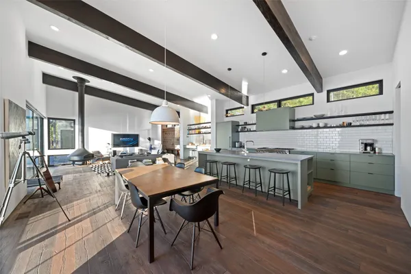a kitchen with a table chairs and cabinets