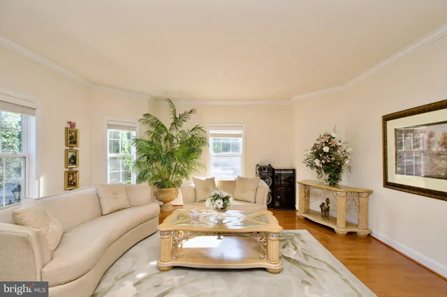 a dining room with furniture a chandelier and wooden floor