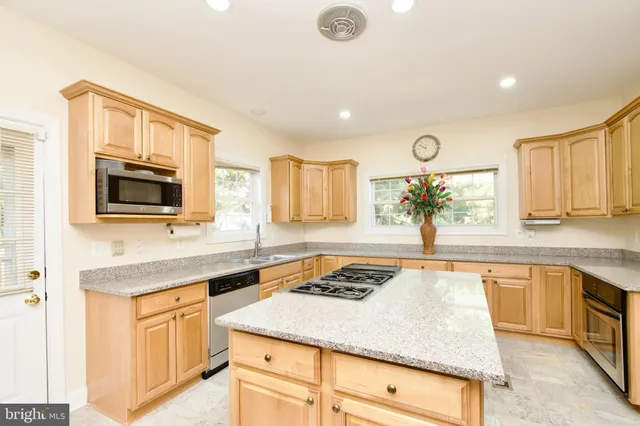 a view of a dining room with furniture and a chandelier