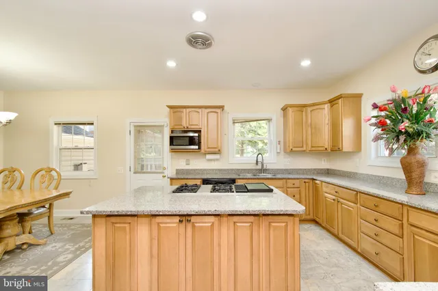 a bedroom with a large bed a flat tv screen and a chandelier