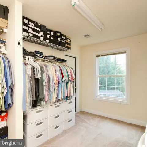 a view of a patio with a table chairs and wooden floor