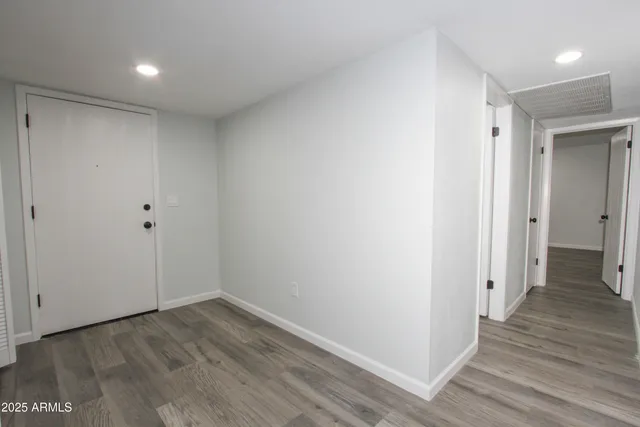 a view of a hallway with wooden floor