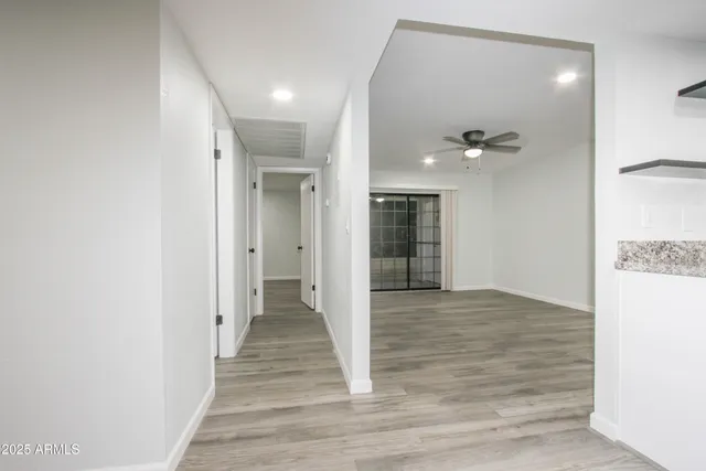 a view of a hallway with wooden floor