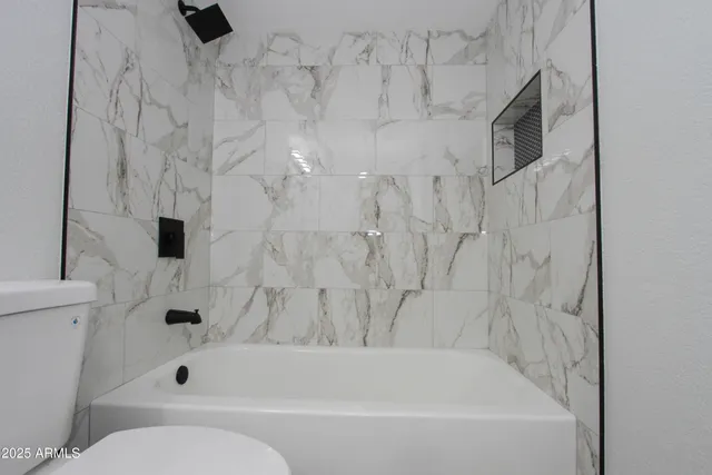 a bathroom with a bathtub and a toilet