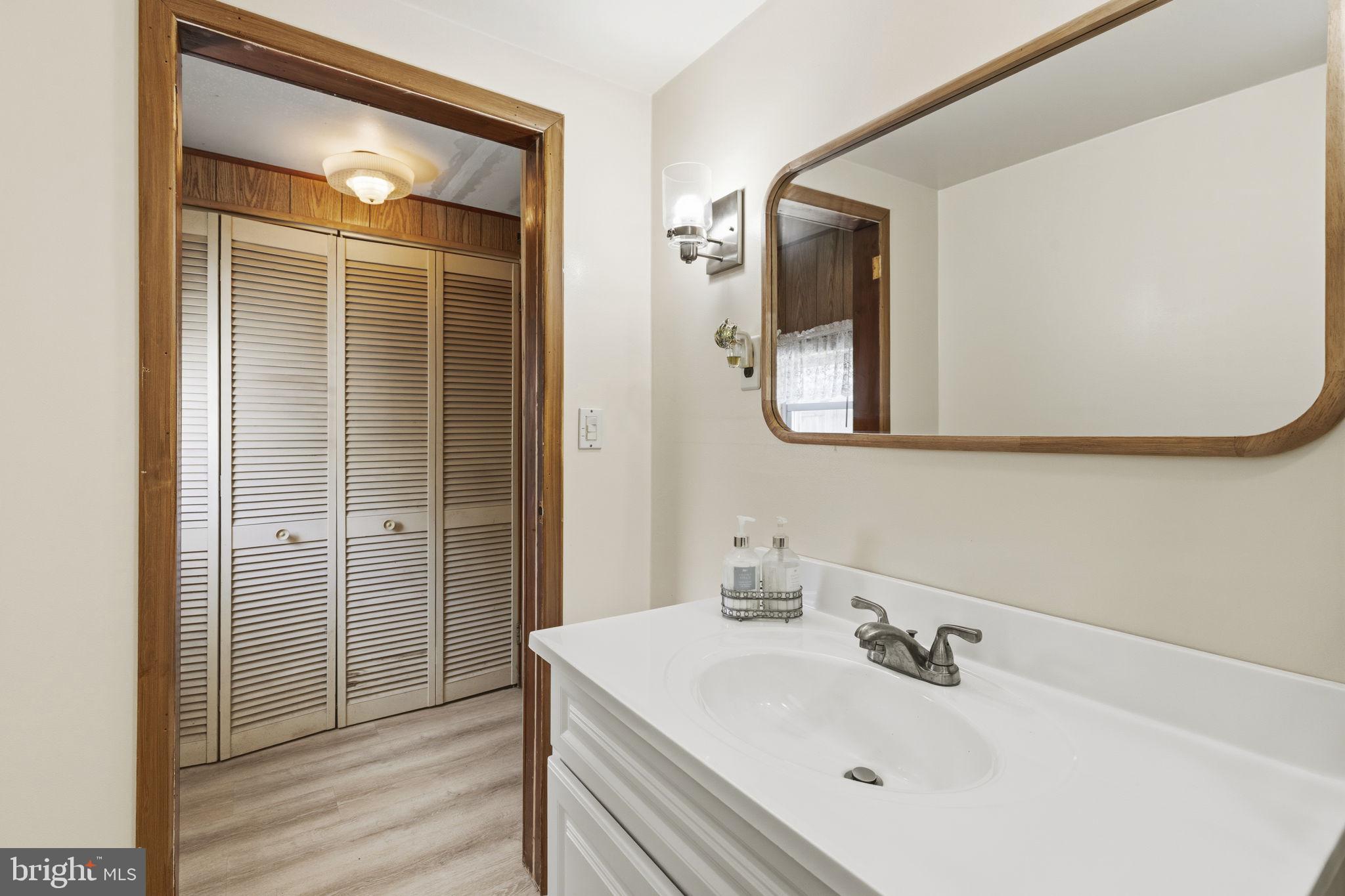 2411 Poplar Road Baltimore, MD 21221 - Photo 16 of 36 a bathroom with a sink vanity and mirror