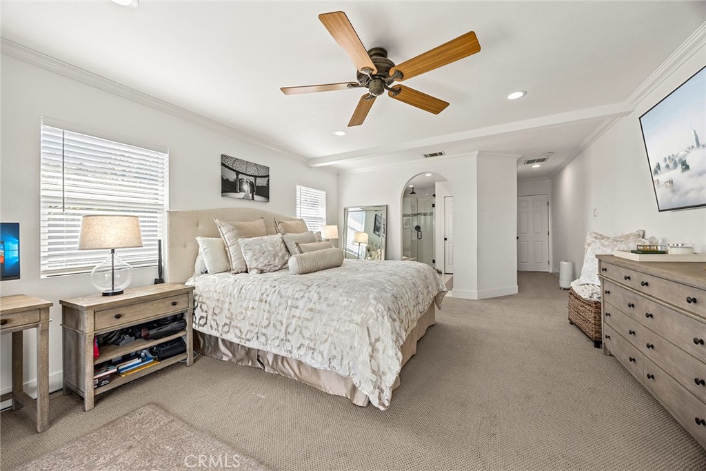 15914 West Road Whittier, CA 90603 - Photo 24 of 47 a spacious bedroom with a bed a dresser and a chandelier