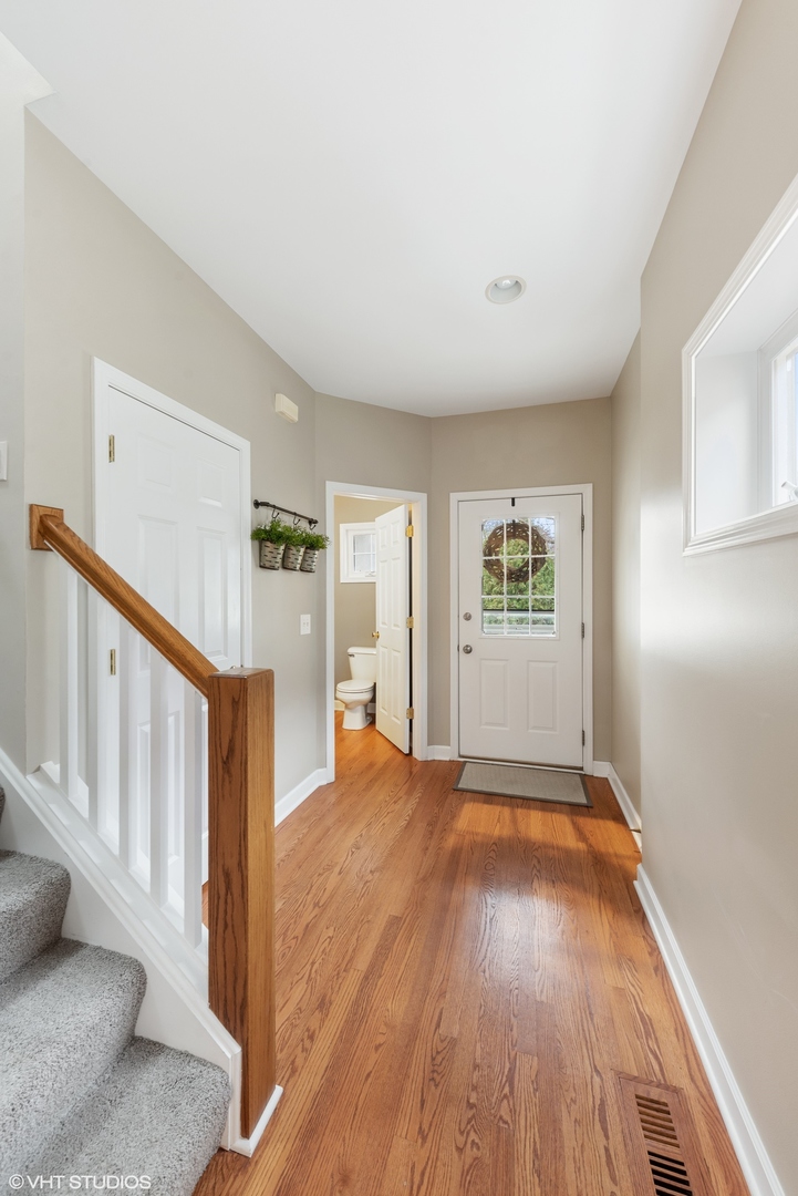 23747 North Quentin Road Lake Zurich, IL 60047 - Photo 2 of 19 a view of an empty room with wooden floor and a window