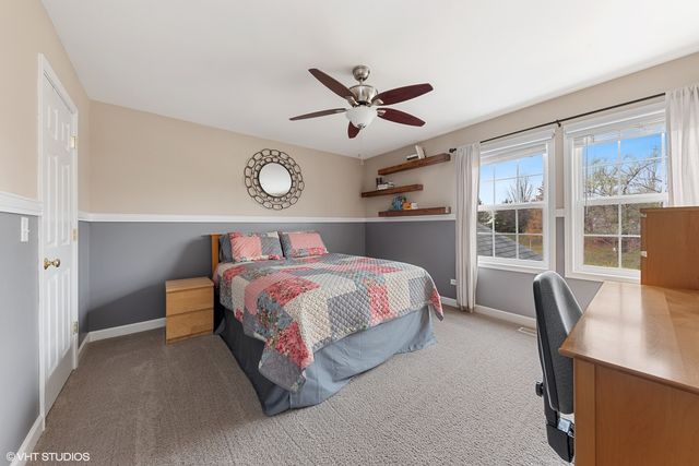 a bed room with a bed and a large window