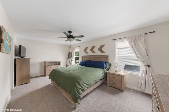 a bedroom with a bed dresser and a window