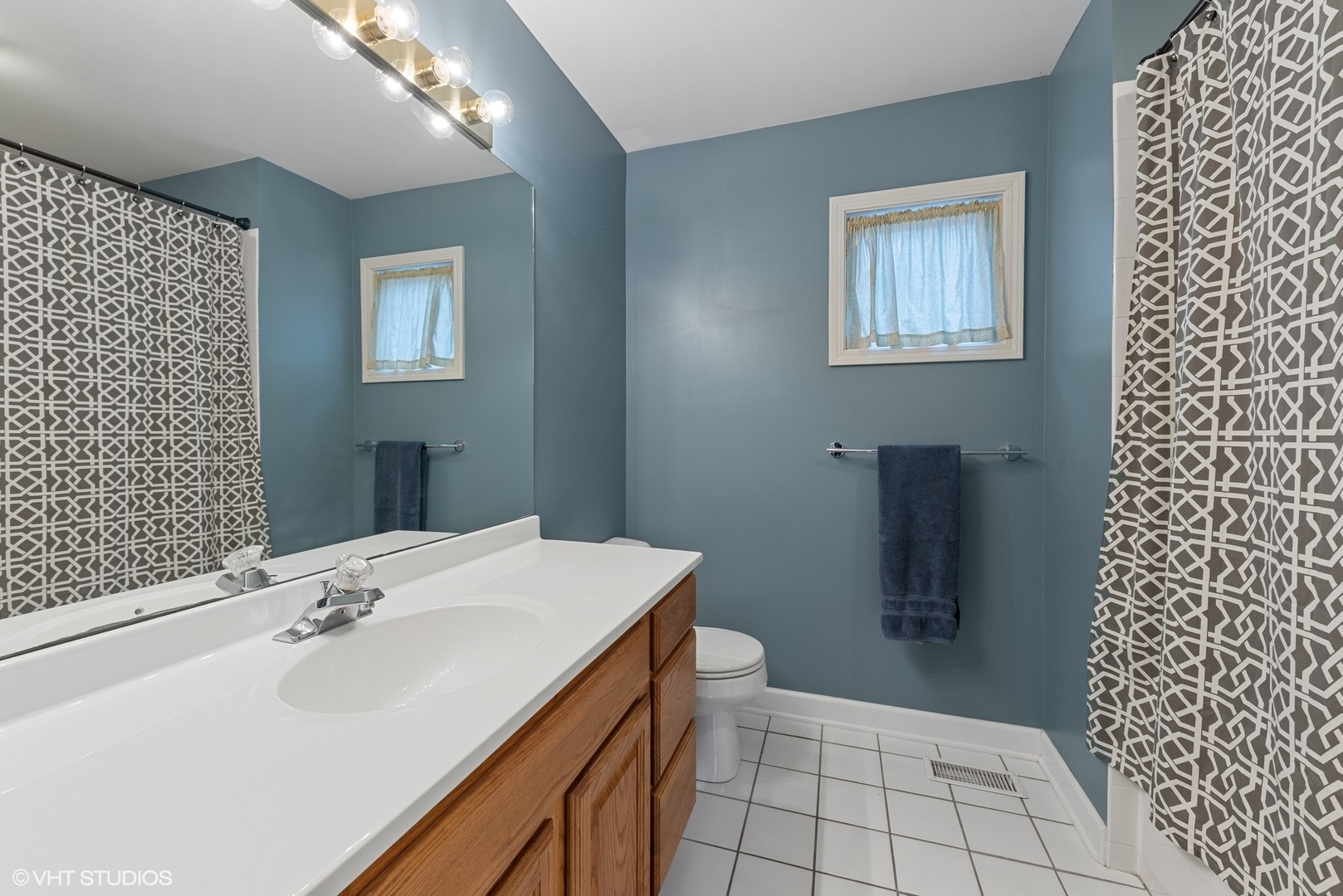 23747 North Quentin Road Lake Zurich, IL 60047 - Photo 9 of 19 a bathroom with a sink a toilet and shower