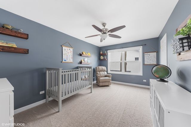 a bedroom with furniture and a large window