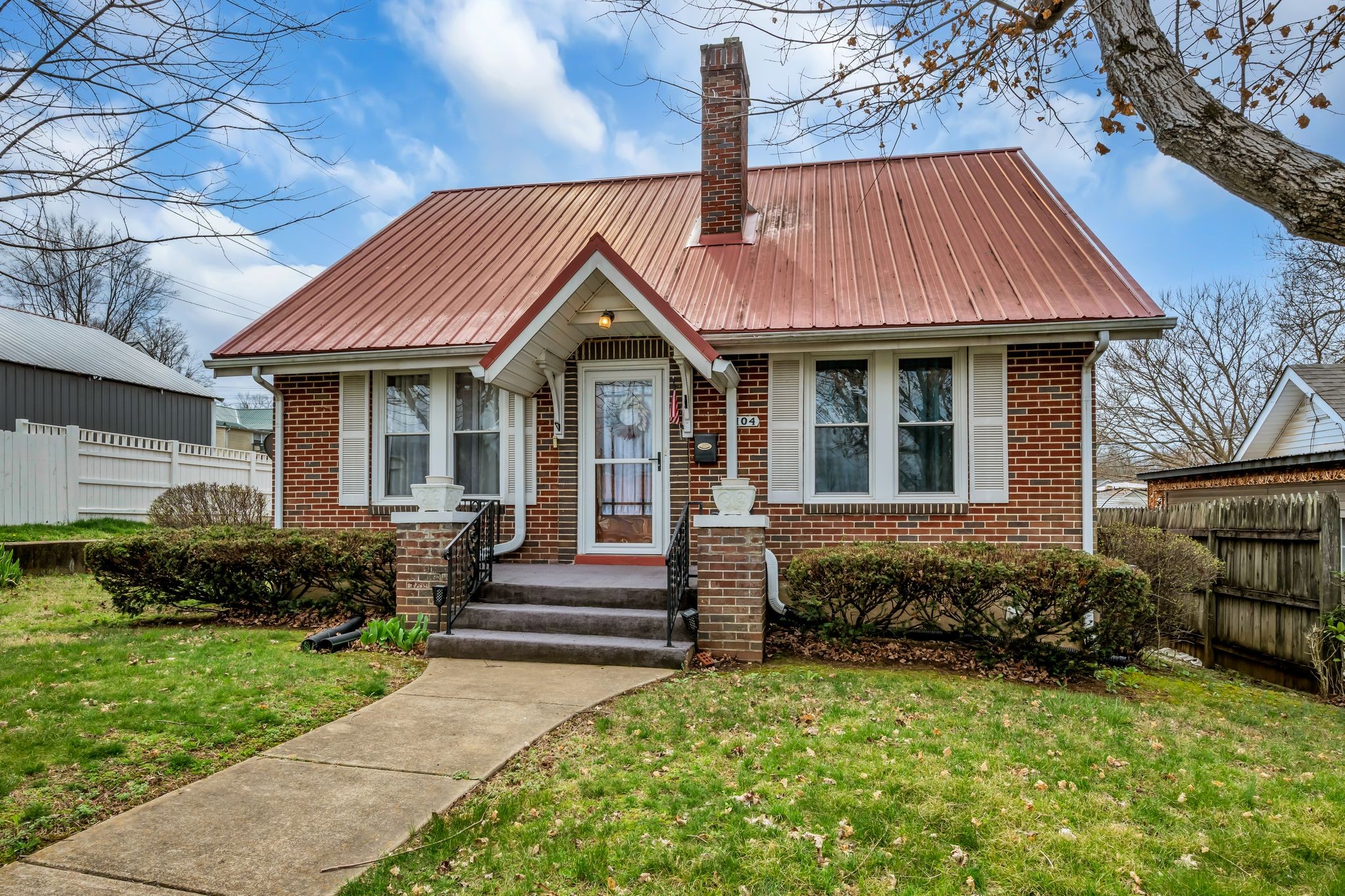 104 West Chestnut Street Dickson, TN 37055 - Photo 2 of 27 a front view of a house with a garden and plants