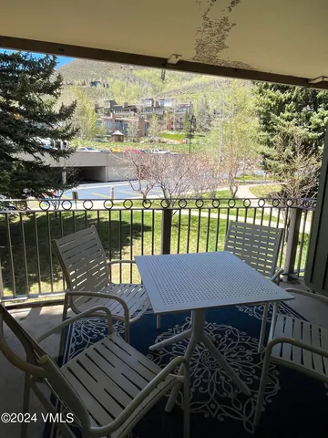 a view of a balcony with two chairs and a table