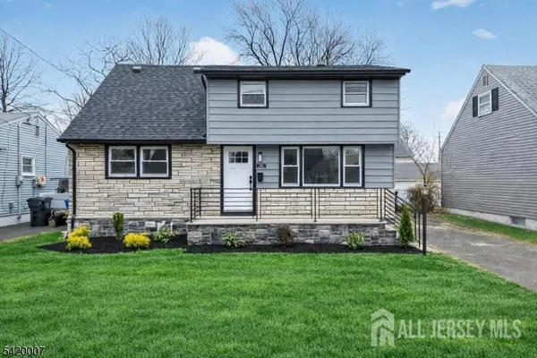 a view of a house with a yard and sitting area