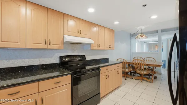 a kitchen with granite countertop sink cabinets and stainless steel appliances