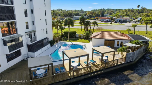 an aerial view of multiple houses with yard