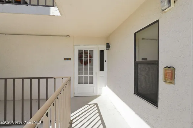 a view of a hallway with windows and stairs