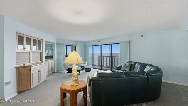 a living room with furniture fireplace and a window