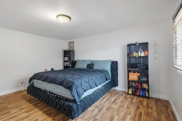 a bedroom with a bed and a book shelf