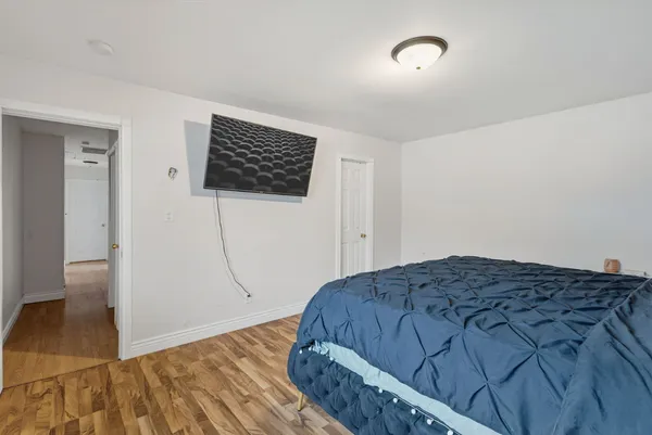 a bedroom with a bed and a view of kitchen