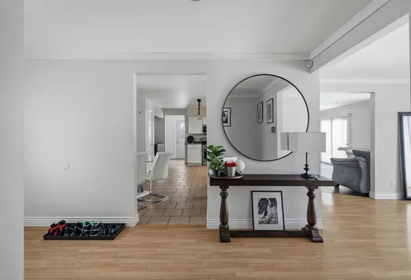 a living room with furniture a mirror and a table