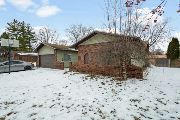 a backyard of a house with a yard and garage