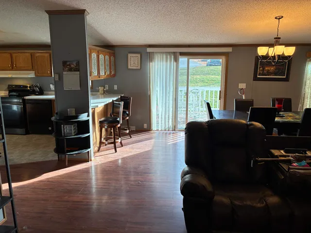 a bedroom with a bed dresser and a large window