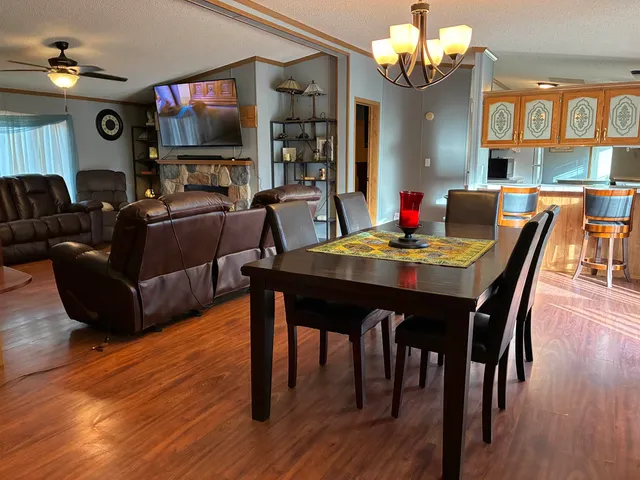 a living room with furniture and a ceiling fan