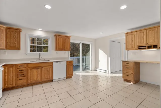 a kitchen with a stove sink and cabinets